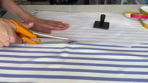 The process of creating clothes in the atelier. Professional cutter using Stock Footage 312565631