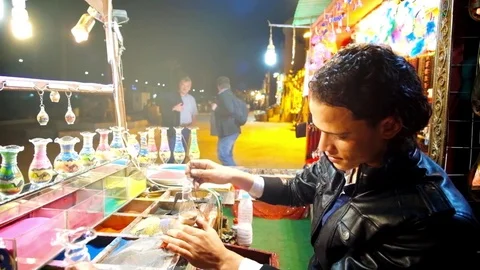 The process of creating colored sand in bottles in Sharm El Sheikh Stock Footage 83926733