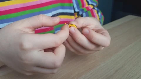 Process of creating crafts from beads. Hands in action. Stock Footage 240249341