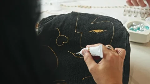 The process of creating custom-made jeans with a unique pattern by a skilled Stock Footage 312648292