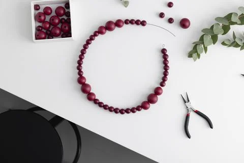 The process of creating a decorative wreath made of beads. Flat lay Stock Photos