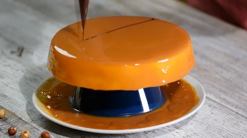 Process of creating delicious cake. Unrecognizable confectioners hands decorate Stock Footage 99860123