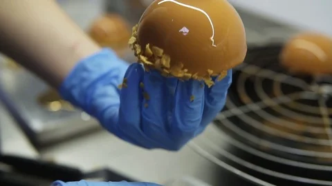 Process of creating delicious dessserts. Unrecognizable confectioners hands in Stock Footage 84870218