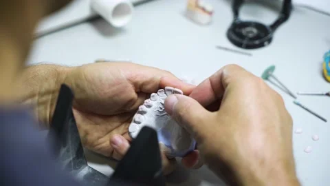 The process of creating a dental crown and impression by a dental technician. Video stock 206076644