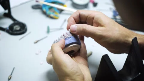 The process of creating a dental crown and impression by a dental technician. Stock Footage 210554801