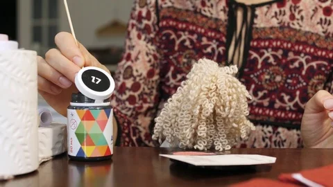 Process of creating a doll: master draws a toy eyes. Close-up. Stock Footage 81618497