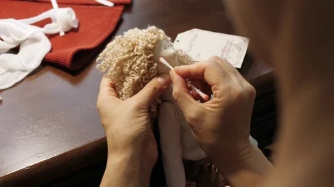 Process of creating a doll: master draws a toy cheeks. Close-up. Stock Footage 81619761