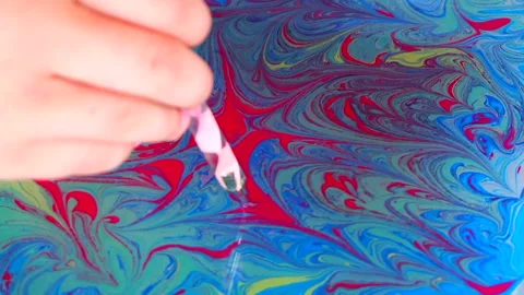Process of creating drawings in ebru technique Stock Footage 156791076