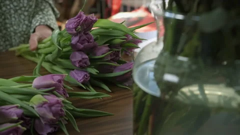 Process of creating floral composition in flower shop, vase in foreground Stock Footage 194419992