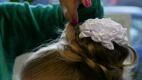 Process of creating hairstyle from braiding braids for young girl in barbershop. Stock Footage 142666748