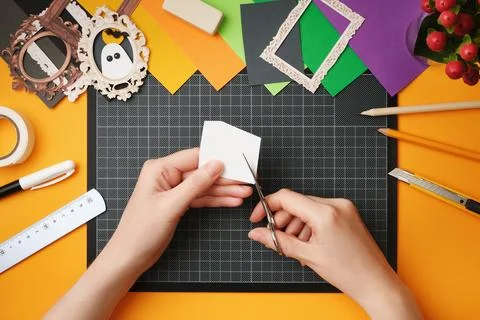 The process of creating a Halloween craft. Cut out the silhouette of a ghost  Stock Photos