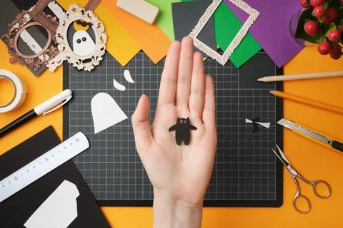 The process of creating a Halloween craft. A finished silhouette of a cat mad Stock Photos