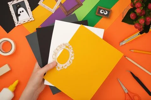 The process of creating a Halloween craft. Take some colored paper. Stock Photos