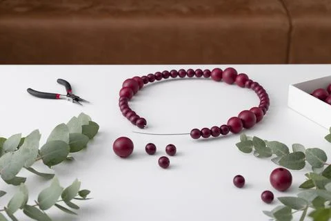 The process of creating hand made wreath made of wire, beads and eucalyptus. Stock Photos