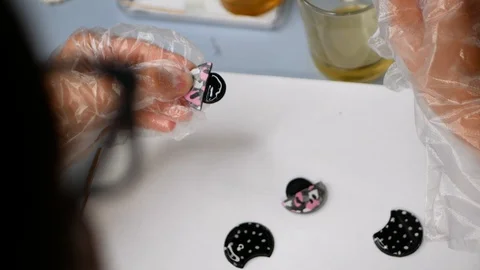 Process of creating jewelry in creative studio. Woman applies paint on ceramic j Stock Footage 127772776