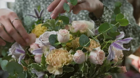 Process of creating lush beautiful composition of pink yellow and purple flowers Stock Footage 182021119
