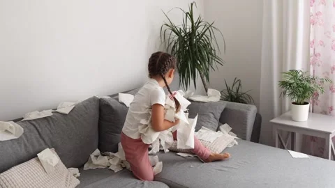 The process of creating a mess by a child. Little girl scatters napkins in Stock Footage 258024666