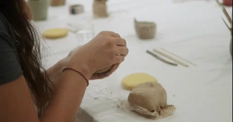 The process of creating a mug from clay at the beginner level in workshop. Stock Footage 276618623