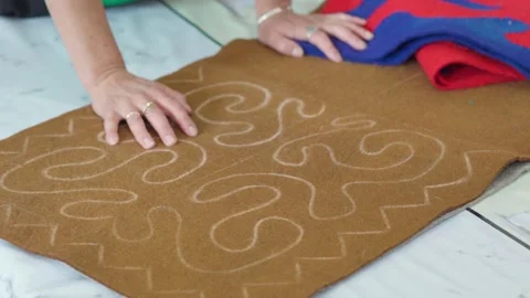 The process of creating a pattern or pattern on brown fabric or felt by hand. Stock Footage 327917067