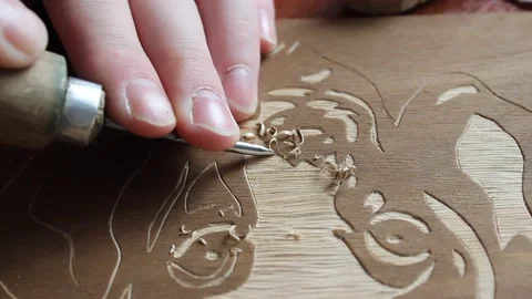 The process of creating a picture of wood. Art wood carving dog Stock Footage 155860720
