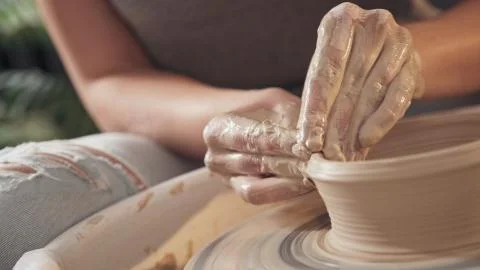 The process of creating pottery on a potter's wheel. Close up Stock Photos