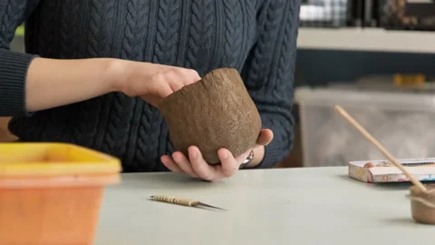 Process of creating pottery. Woman forming clay in pottery studio. Stock Footage 237308705
