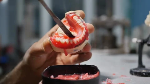 The process of creating a removable denture by a master dental technician in the Stock Footage 210909900