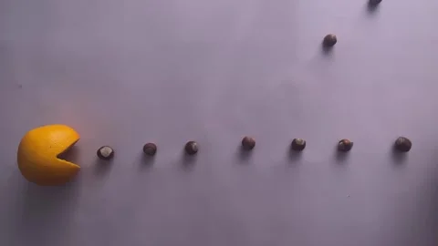 Process of creating a stop motion video with pacman and fruits Stock Footage 262232255