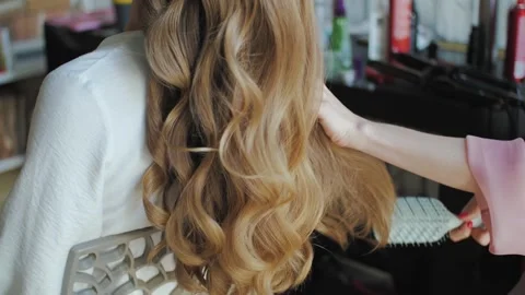 The Process of Creating Stylish Hair with Glamorous Waves for a Chic Appearance Stock Footage 308787510