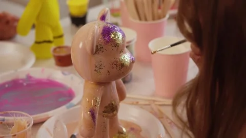 The process of creating unique toys and home decor items using glitter and paint Stock Footage 302649214