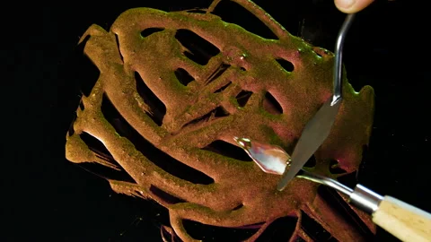 Process of creating watercolor using palette knife and pigment, black background Stock Footage 138801968