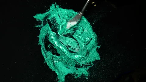 Process of creating watercolor using palette knife and pigment, black background Stock Footage 138807252