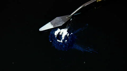 Process of creating watercolor using palette knife and pigment, black background Stock Footage 138808516