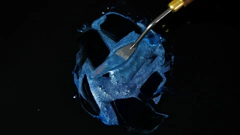 Process of creating watercolor using palette knife and pigment, black background Stock Footage 138808729