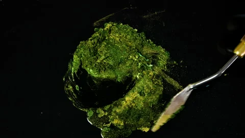 Process of creating watercolor using palette knife and pigment, black background Stock Footage 138808905