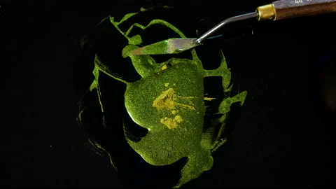 Process of creating watercolor using palette knife and pigment, black background Stock Footage 138809091