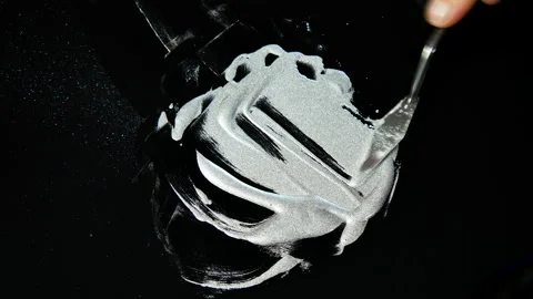 Process of creating watercolor using palette knife and pigment, black background Stock Footage 138809433