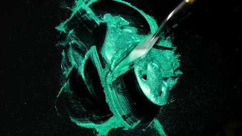 Process of creating watercolor using palette knife and pigment, black background Stock Footage 138809928