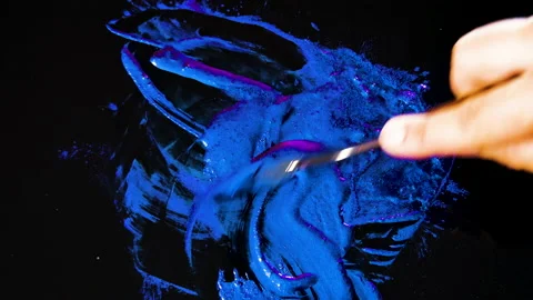 Process of creating watercolor using palette knife and pigment, black background Stock Footage 138809949