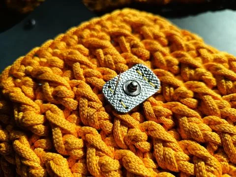 The process of crocheting a handbag made of cord and leather accessories Stock Photos