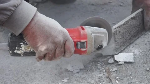 The process of cutting building materials with a grinder machine by a builder Stock Footage 236724120