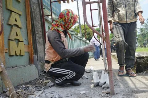 The process of cutting building materials with a grinder machine by a builder Stock Photos