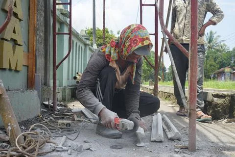 The process of cutting building materials with a grinder machine by a builder Stock Photos