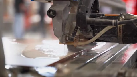 The process of cutting ceramic tiles on a wet saw. Close-up Stock Footage 308520361