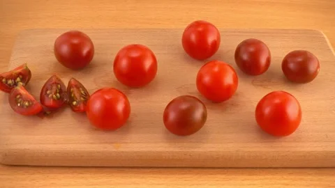 Process cutting cherry tomatoes and cucumber of womens hand with knife and .. Stock Footage 328399037