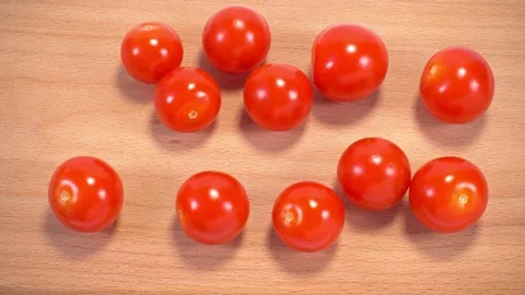 Process cutting cherry tomatoes of women's hand on table on cutting board w.. Stock Footage 328398753