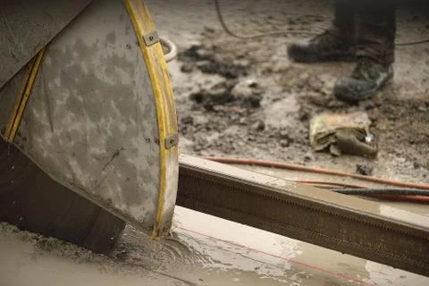 Process of cutting concrete plate with diamond circular saw on construction site Stock Photos