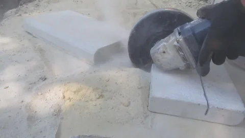 The process of cutting a concrete slab into pieces by an angular grinder - 15s Stock Footage 94256085