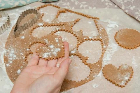Process of cutting cookies by cookie cutters. Woman making by hands forms for Stock Photos