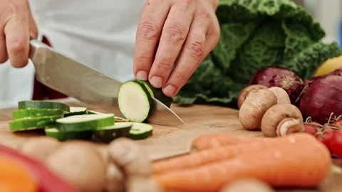 The process of cutting cucumbers. A chef's hand with a knife cuts cucumbers on a 스톡 동영상 217513569